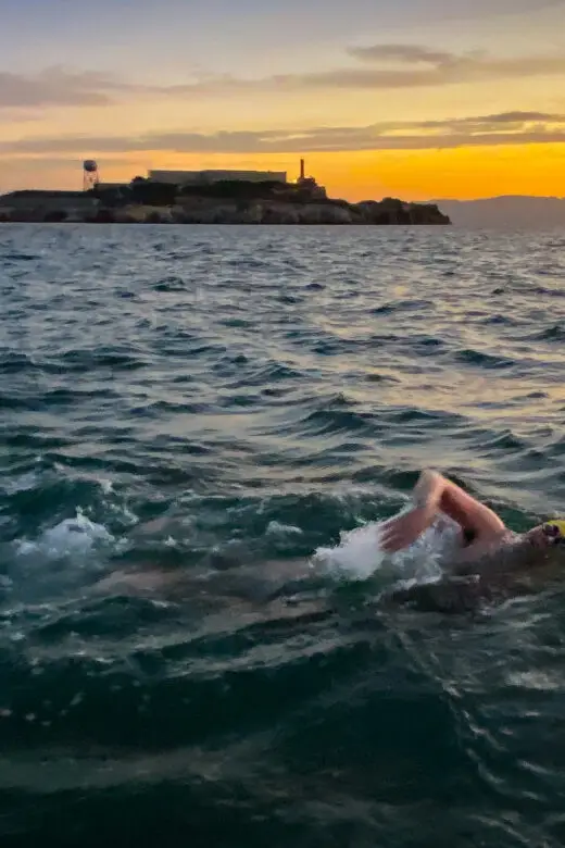 Andrew Packer swimming at dawn during the return leg of the Round-Trip Angel Island marathon swim in San Francisco Bay.